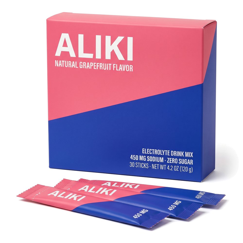 ALIKI Grapefruit electrolyte drink mix, carton of 30 sticks with three sticks in front, on white
