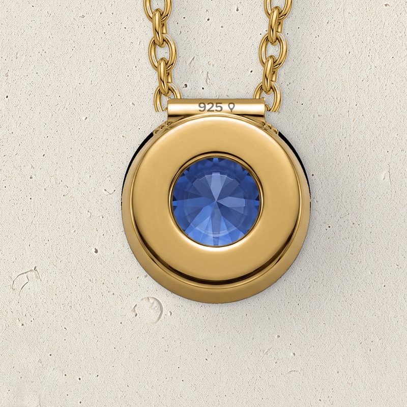The open back of the Corund pendant on pale limestone, stamped 925 on the bail