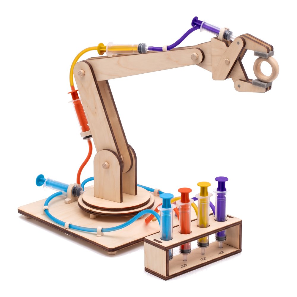 Fulcra hydraulic robotic arm built, four colored water lines, a wooden ring in the gripper, on white
