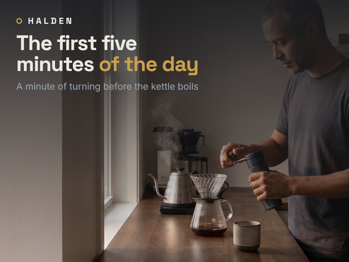 Man grinding coffee with the Halden One at an oak counter, morning kitchen