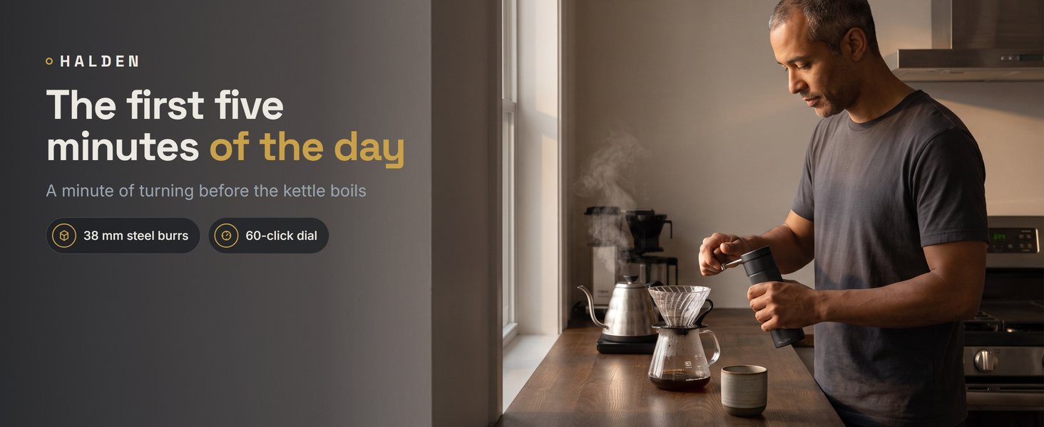 Man grinding coffee with the Halden One at an oak counter, morning kitchen