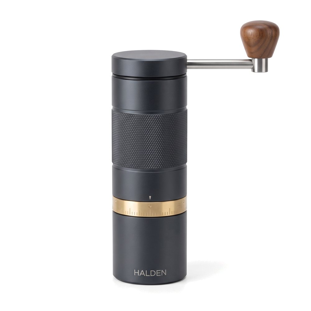 Halden One manual coffee grinder, graphite with walnut knob and brass dial, front view on white