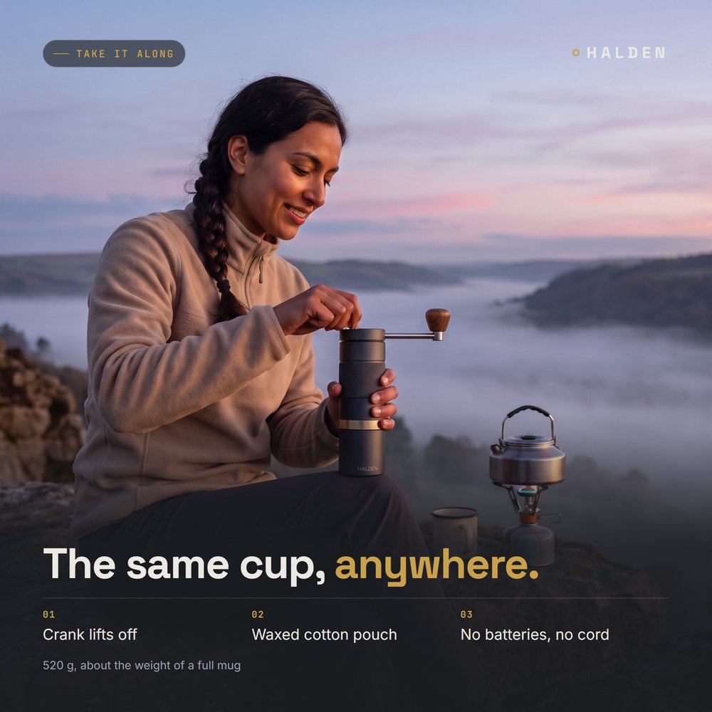 Woman grinding coffee with the Halden One at a dawn campsite by a stove