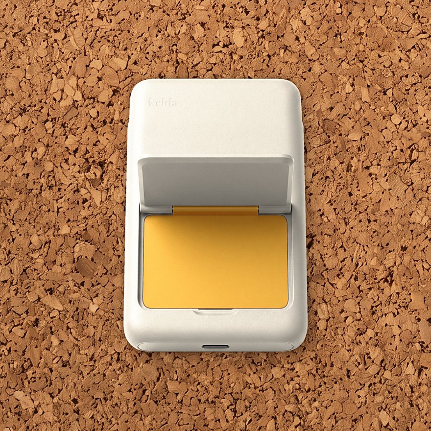 Kelda 37 in Paper, stand open to the marigold inside, on cork