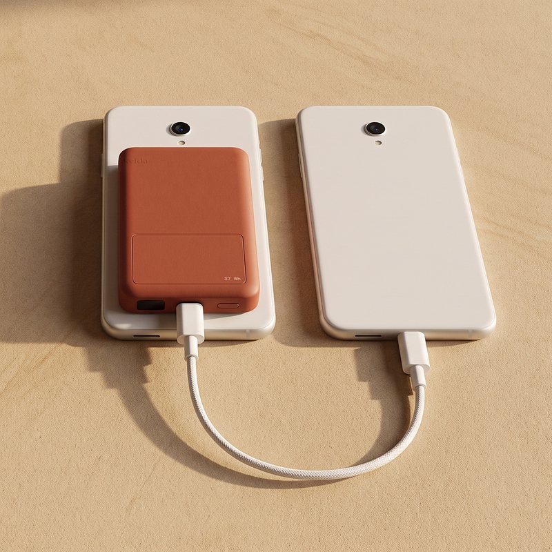 Two phones on sandstone, one with the Kelda 37 pack, a white cable from the pack to the other