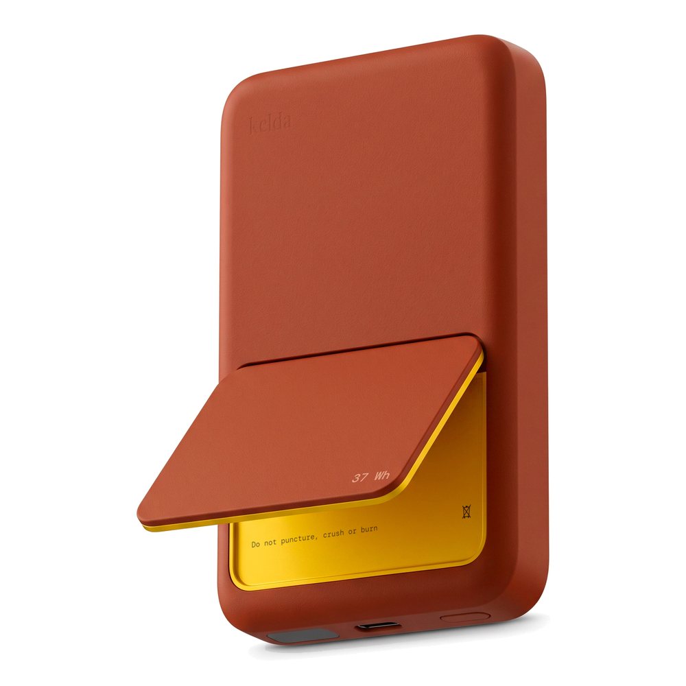 Kelda 37 (37 Wh) magnetic power bank in Clay on white, stand slightly open to the marigold inside