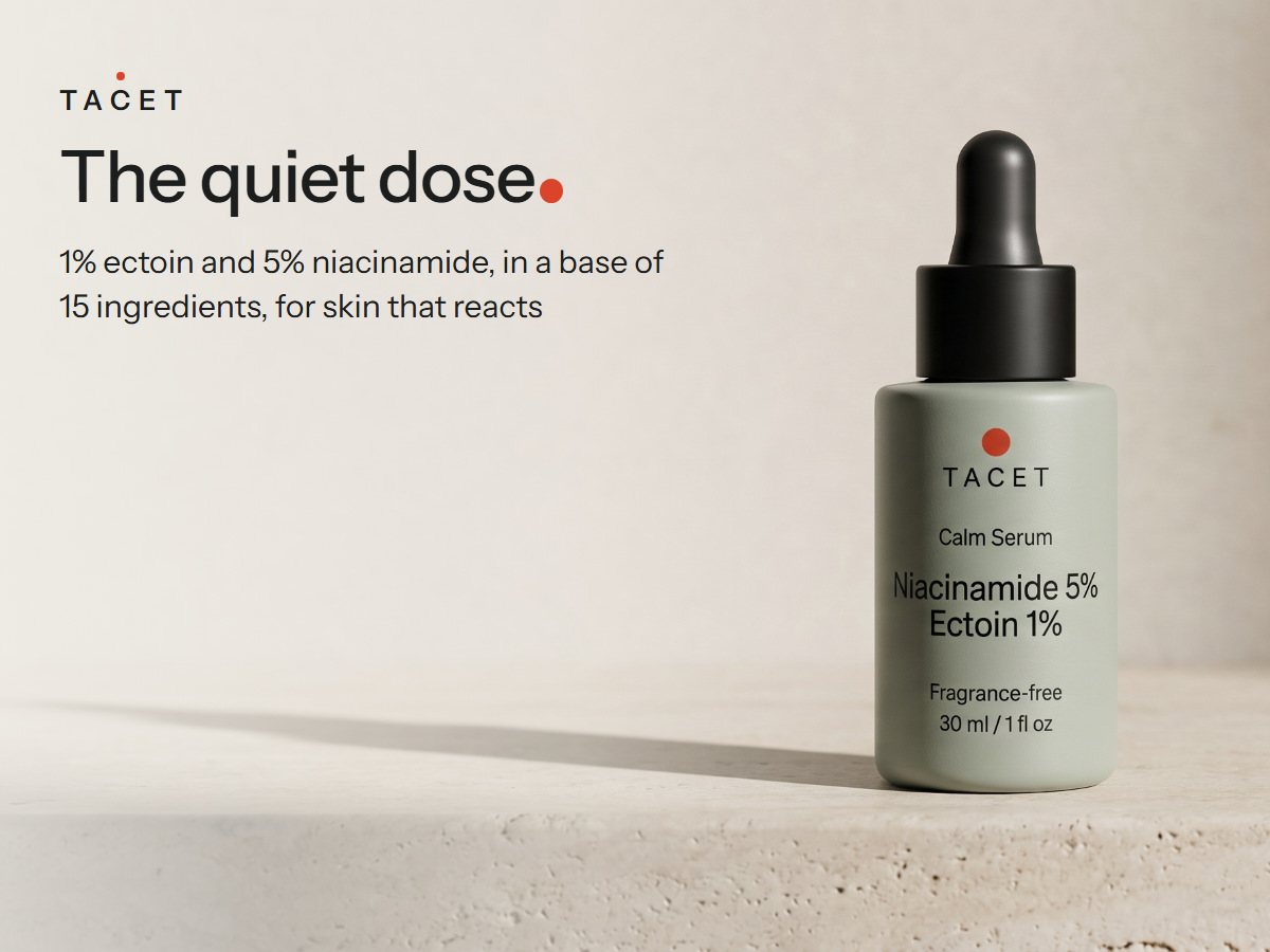 Tacet Calm Serum bottle on a travertine ledge in low side light with one long clean shadow