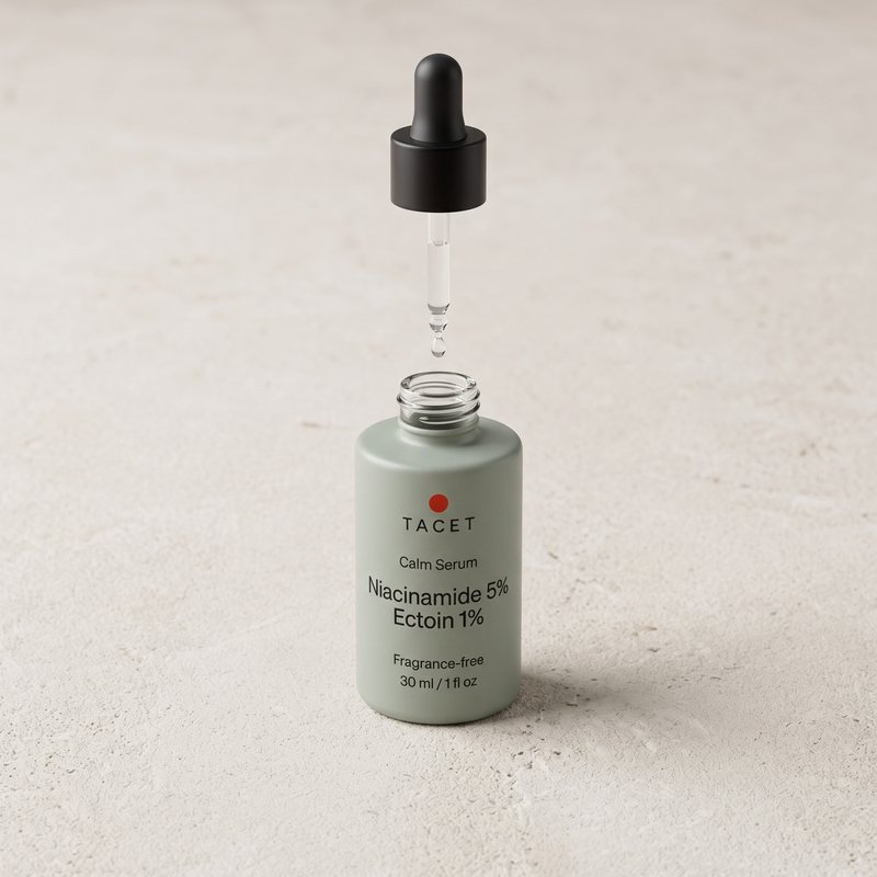 Dropper lifted above the open bottle, one drop forming