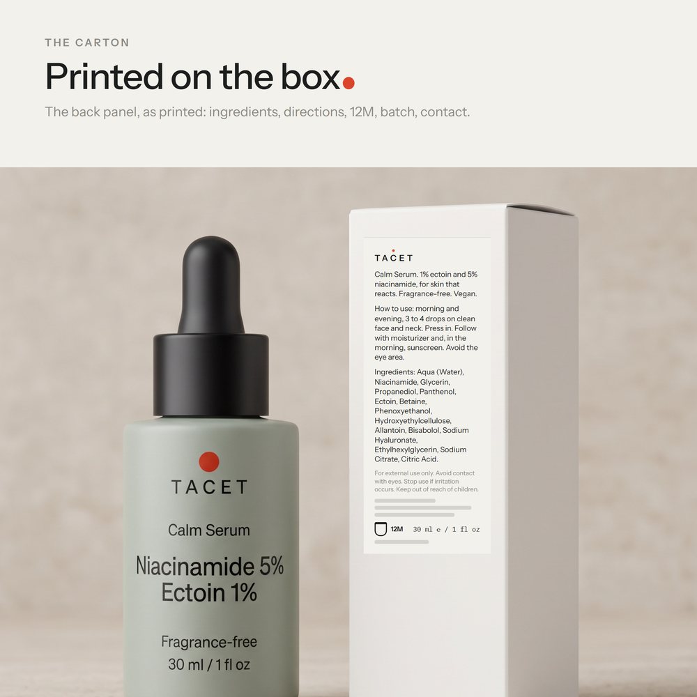 Tacet Calm Serum bottle beside its chalk carton, turned to show the back panel, on travertine