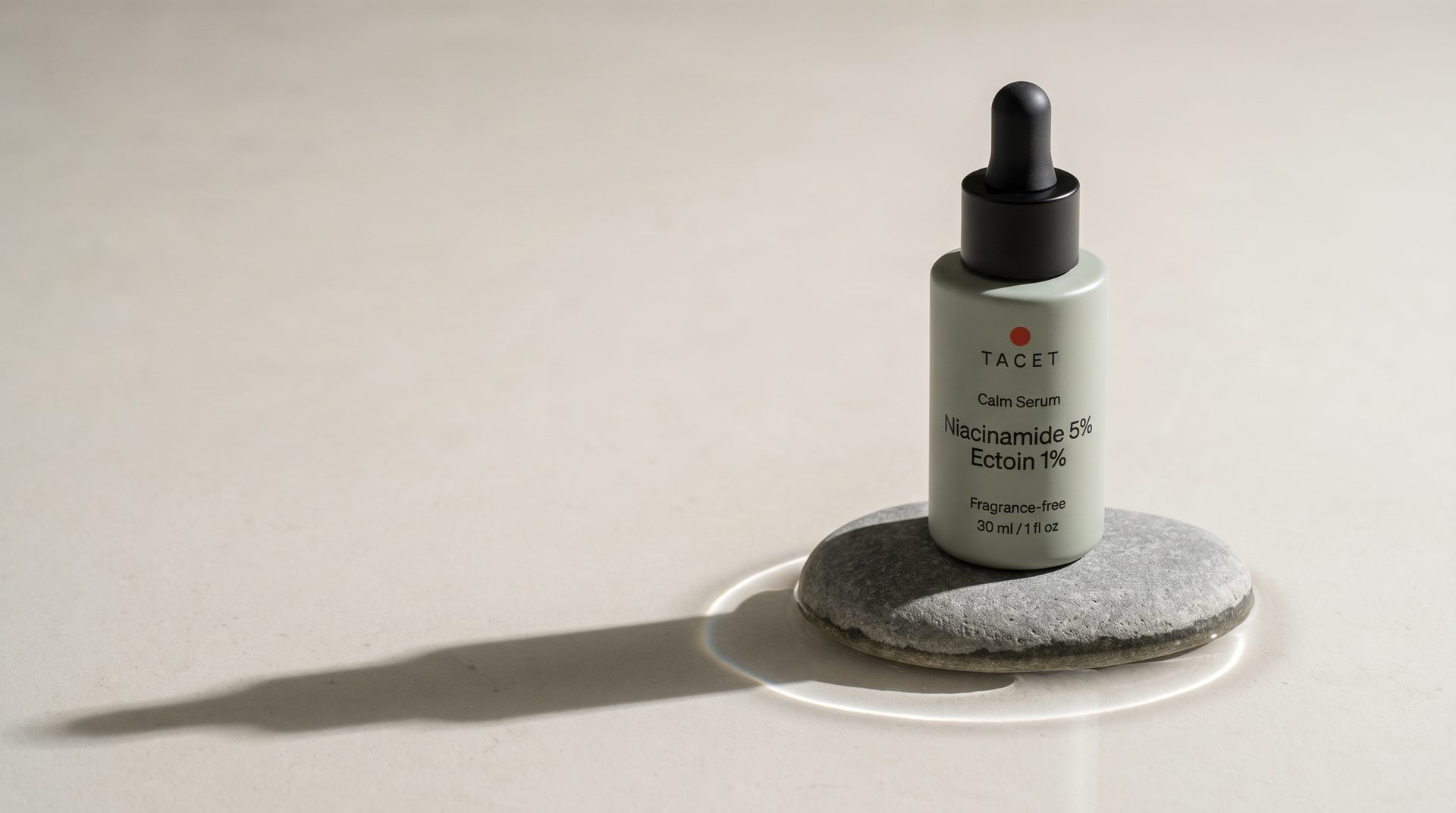 Tacet Calm Serum bottle standing on a stone in still water